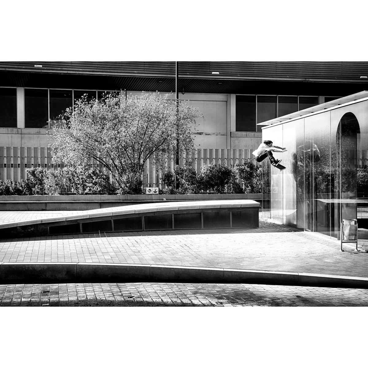 Evan Smith, kickflip wallride off glass building facade, Barcelona 2015, black and white — fine art skate photography print by David Broach
