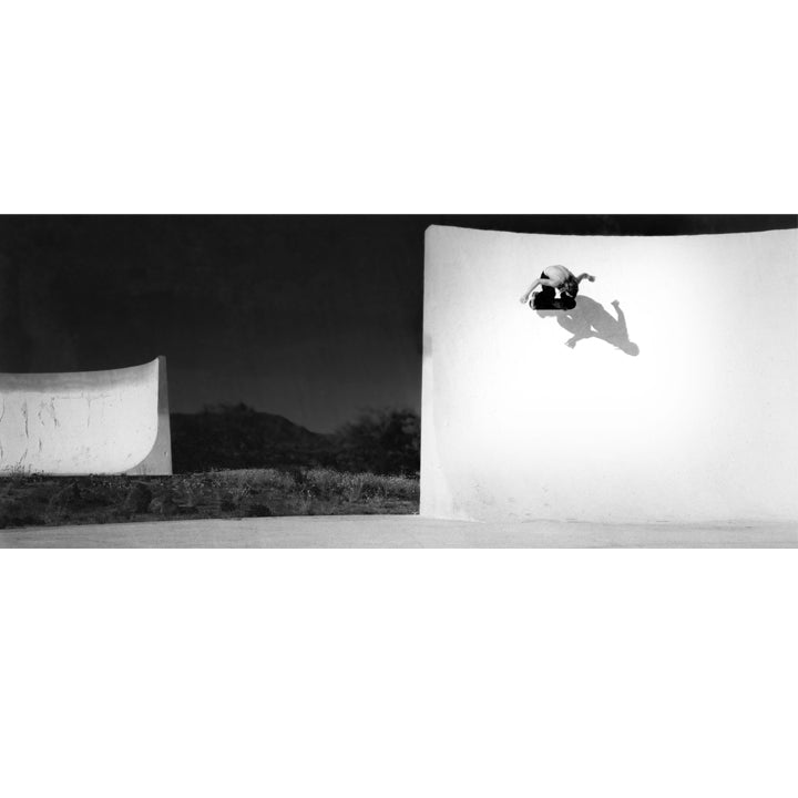 Chad Muska, aerial view over abandoned concrete car cove bowl at night, Phoenix Arizona, 1999, black and white film — fine art skate photography print by David Broach